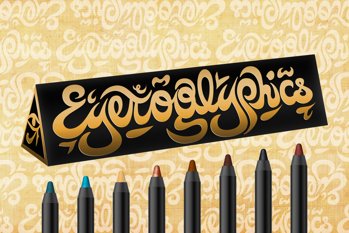 A set of colorful eyeliners is displayed in front of a black and gold geometric box labeled Eyeoglyphics. The background features a matching gold script pattern on a beige surface.