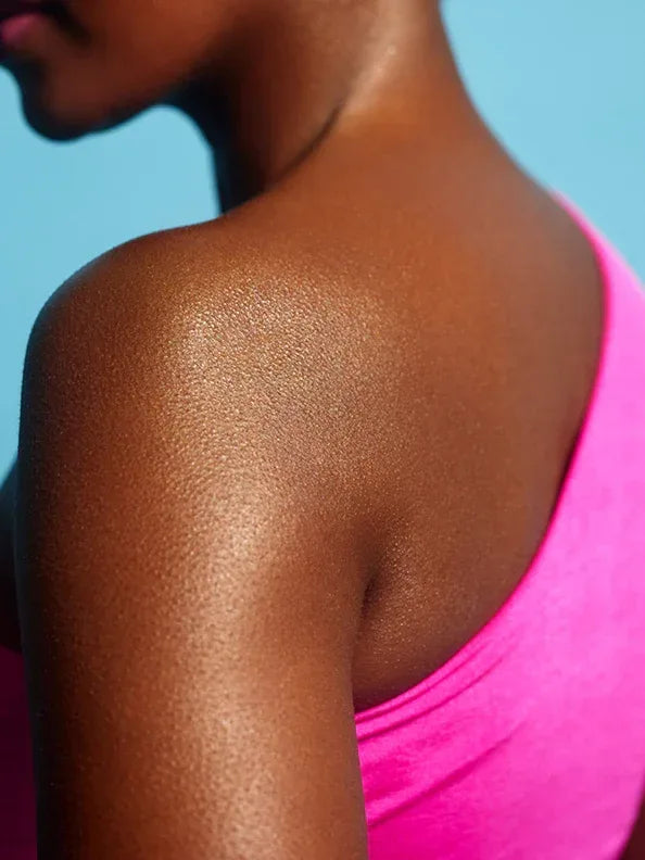 body glaze body shimmer by peaches and cream shown being worn on models shoulder