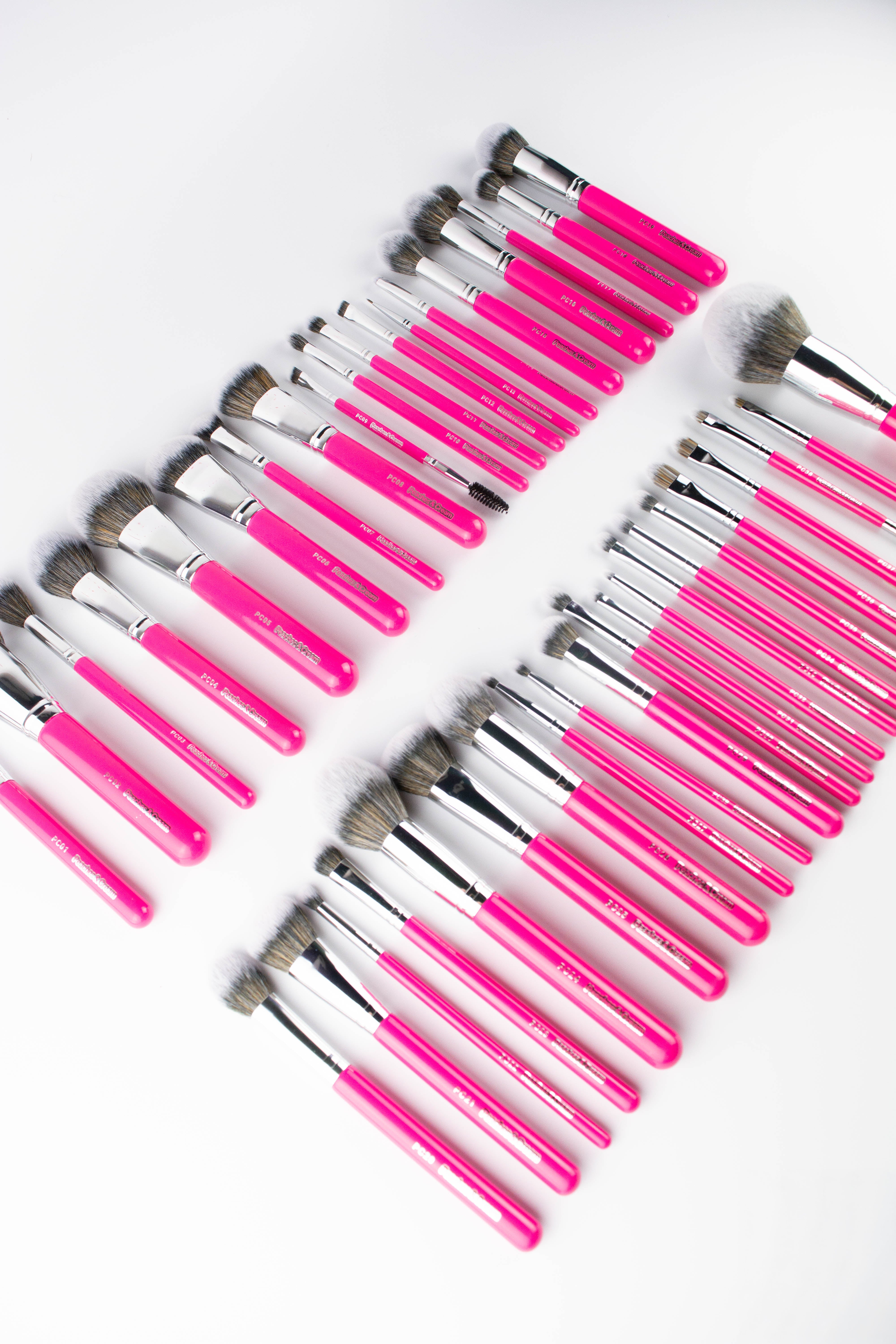 Set of makeup brushes with pink handles for face and eye makeup