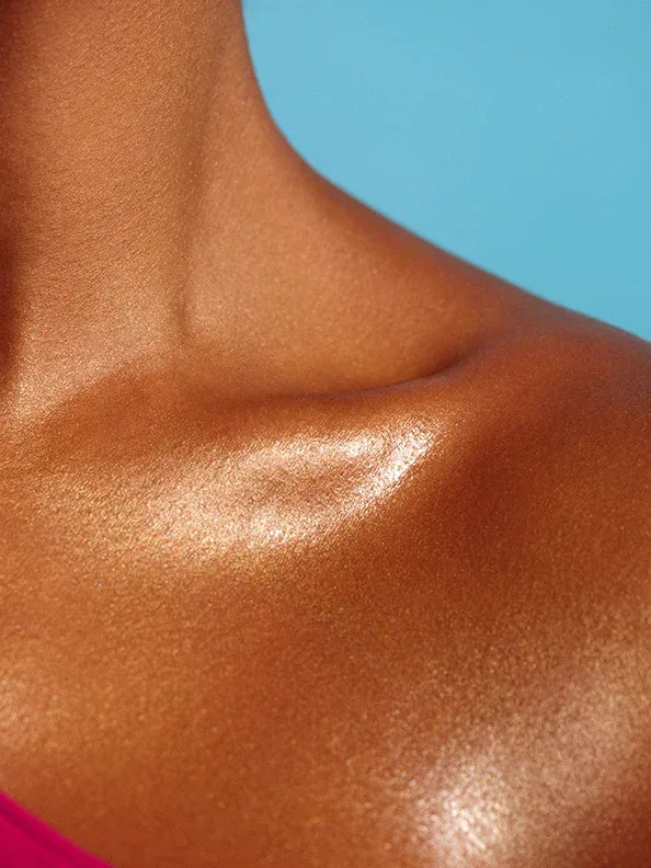 body glaze body shimmer by peaches and cream shown being worn on models collarbone