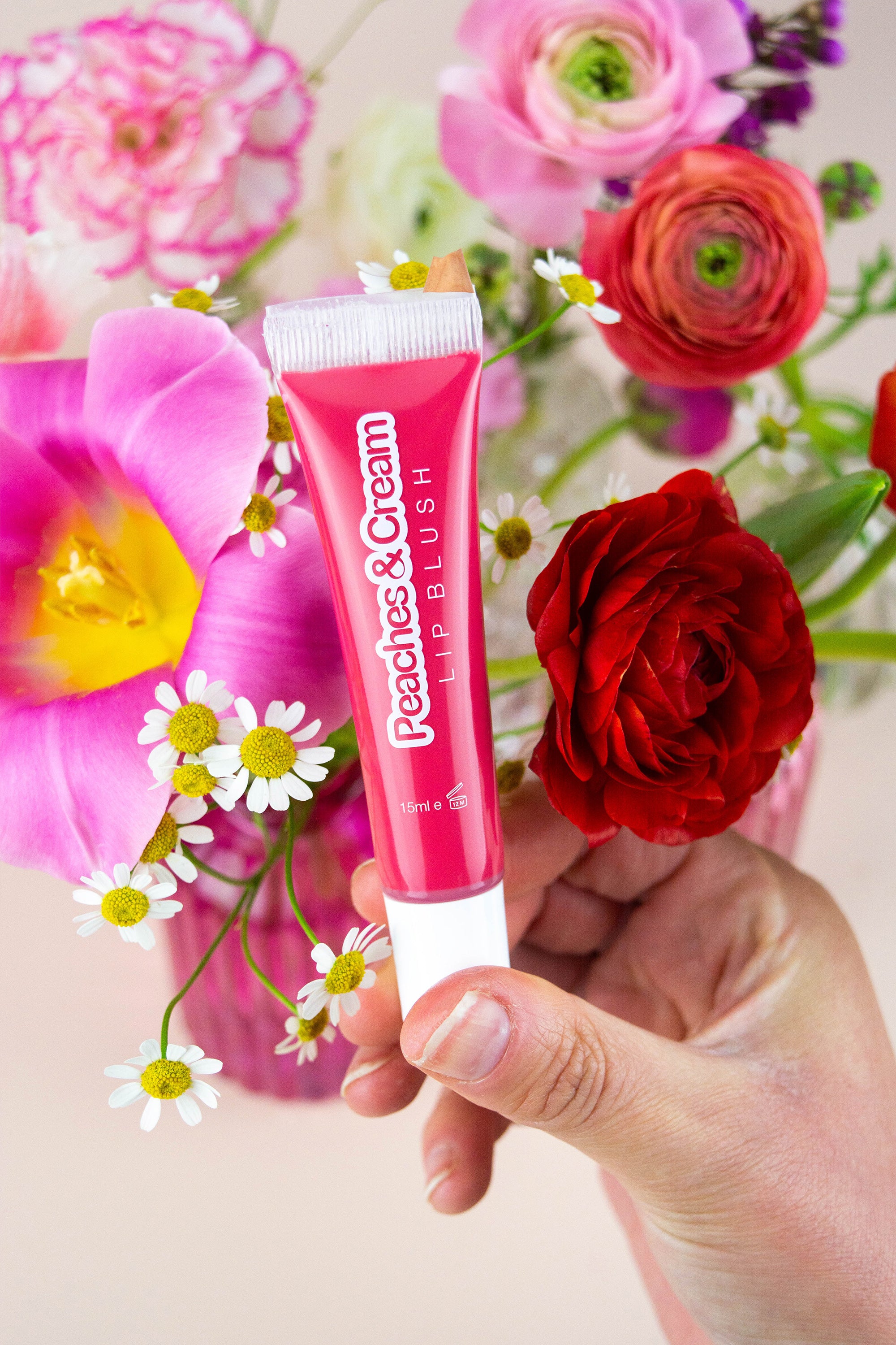 Poppy lip blush displayed with flowers
