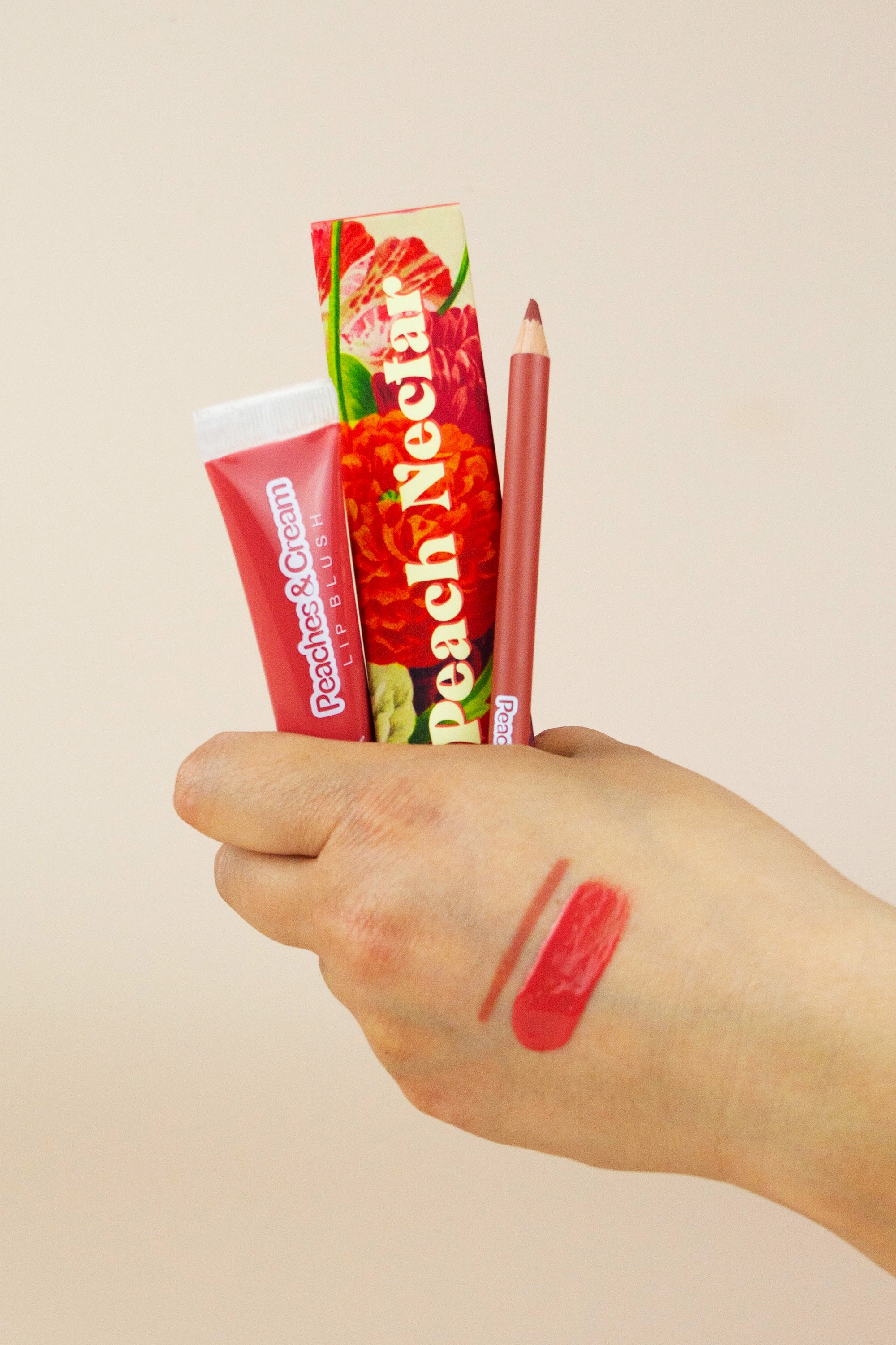 Peach Nectar Lip Blush Kit swatched on model's hand