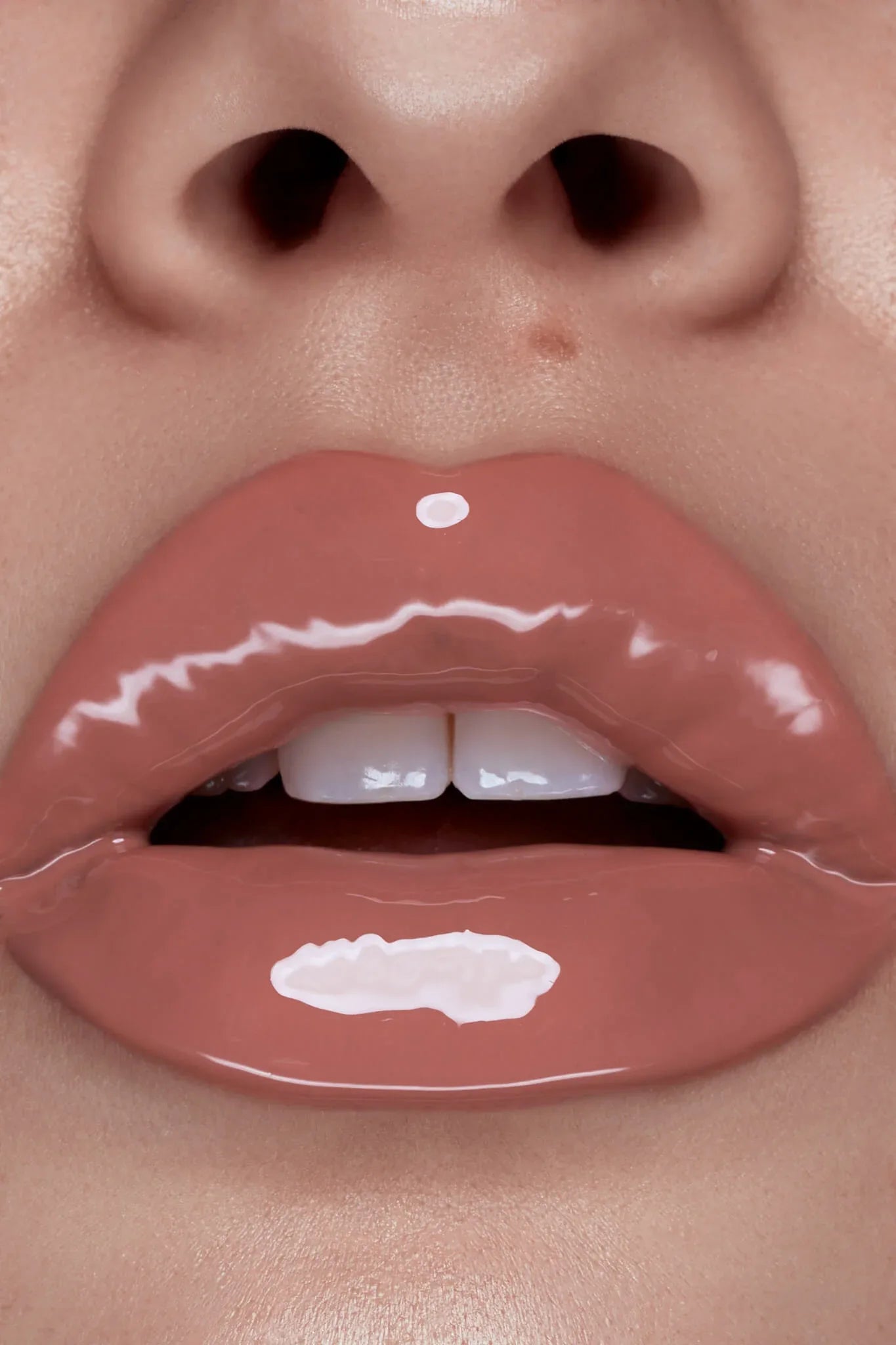 Bambi lip gloss shown on model's lips by Peaches & Cream