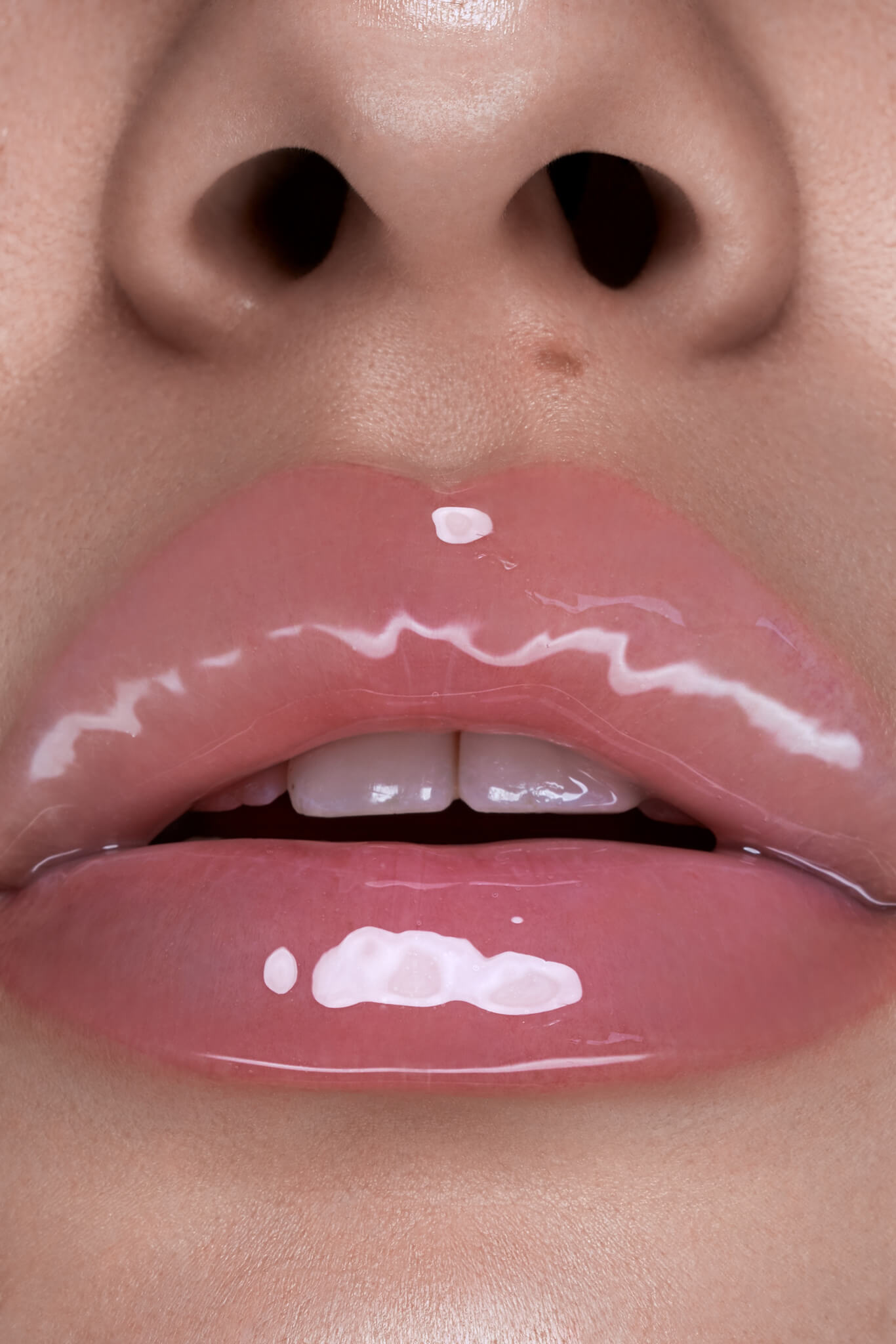 Clear lip gloss shown on model's lips