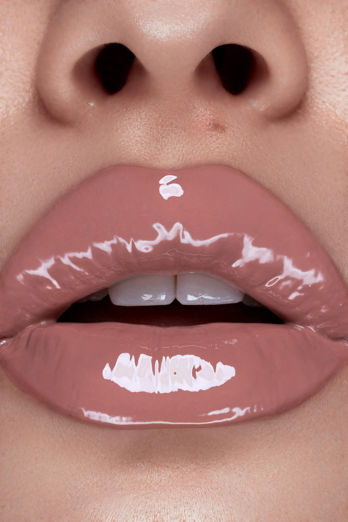 Hunny lip gloss shown on model's lips
