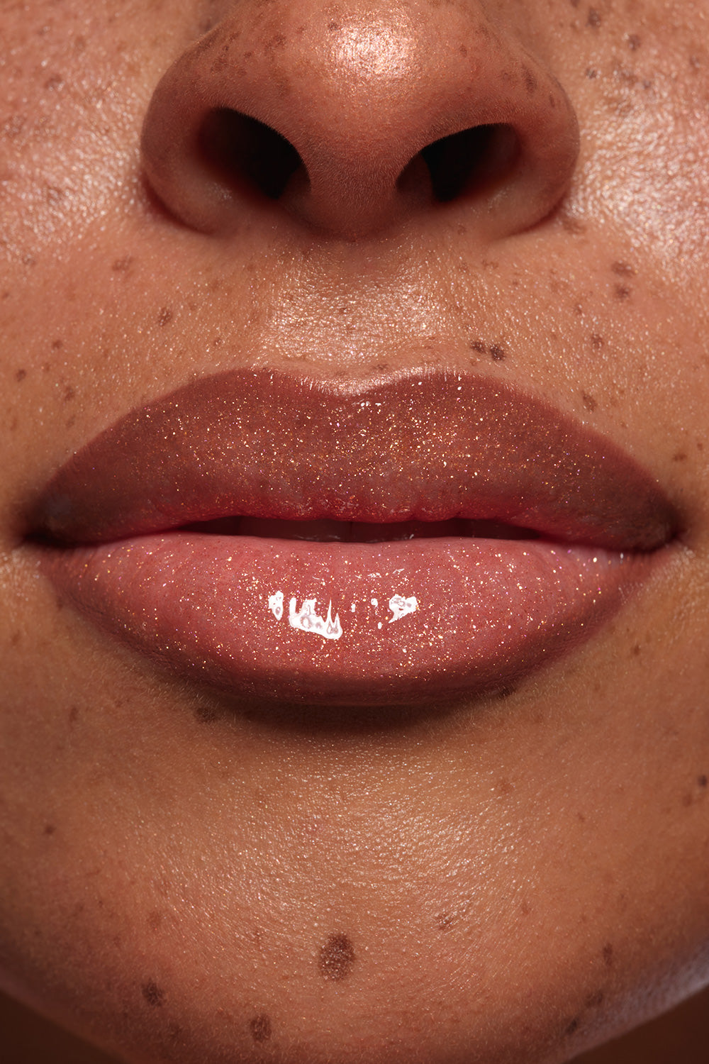 Supernova lipgloss shown on model's lips