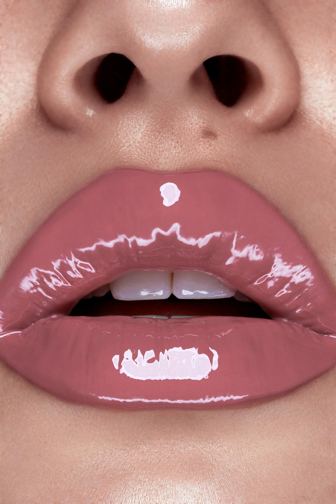 Suede lip gloss shown on model's lips