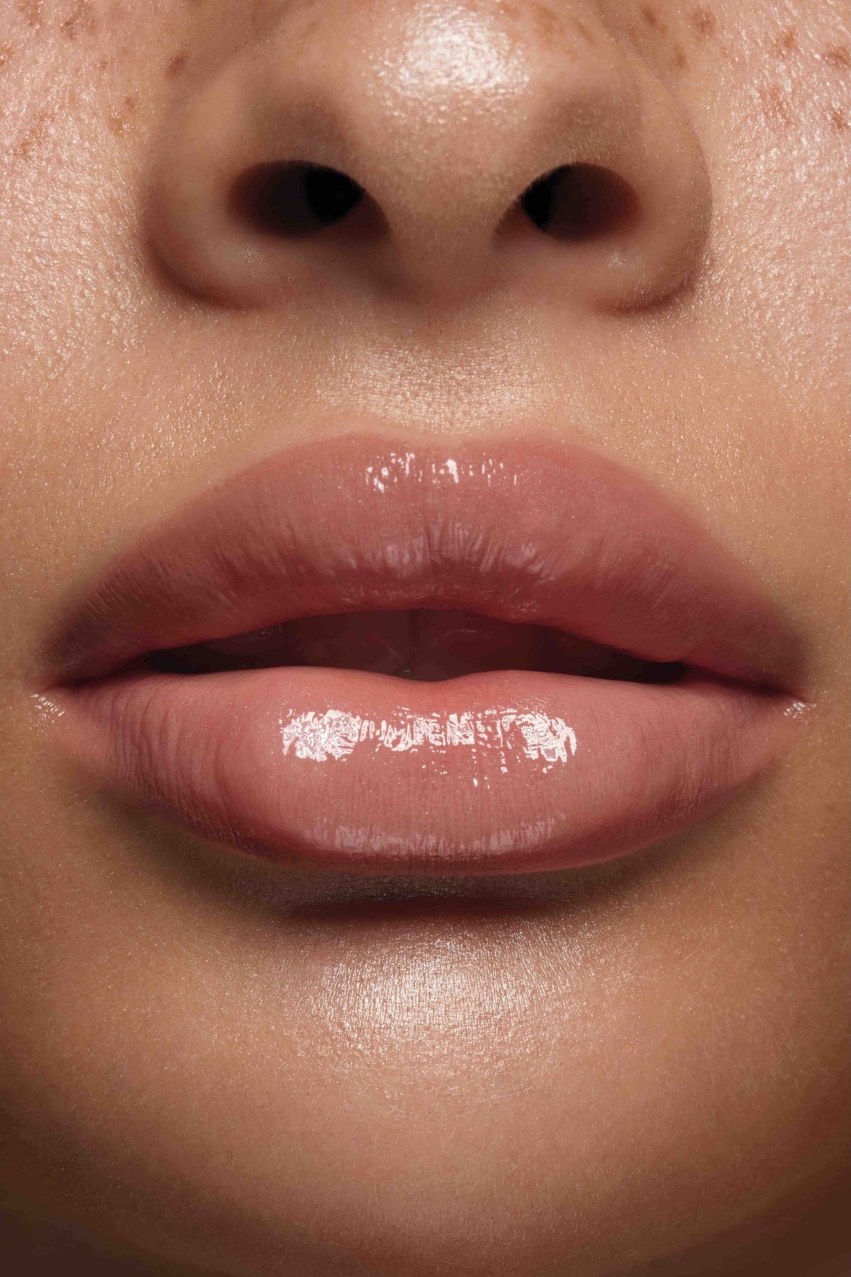 Bare lip gloss shown on model's lips by Peaches & Cream