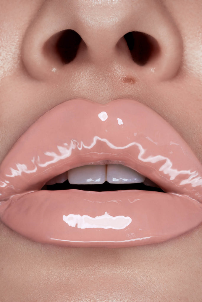 Sisterhood lip gloss shown on model's lips